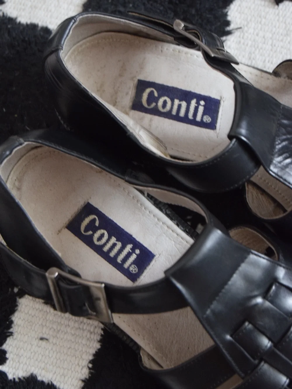 Black leather woven sandals / huaraches with buckle detail.